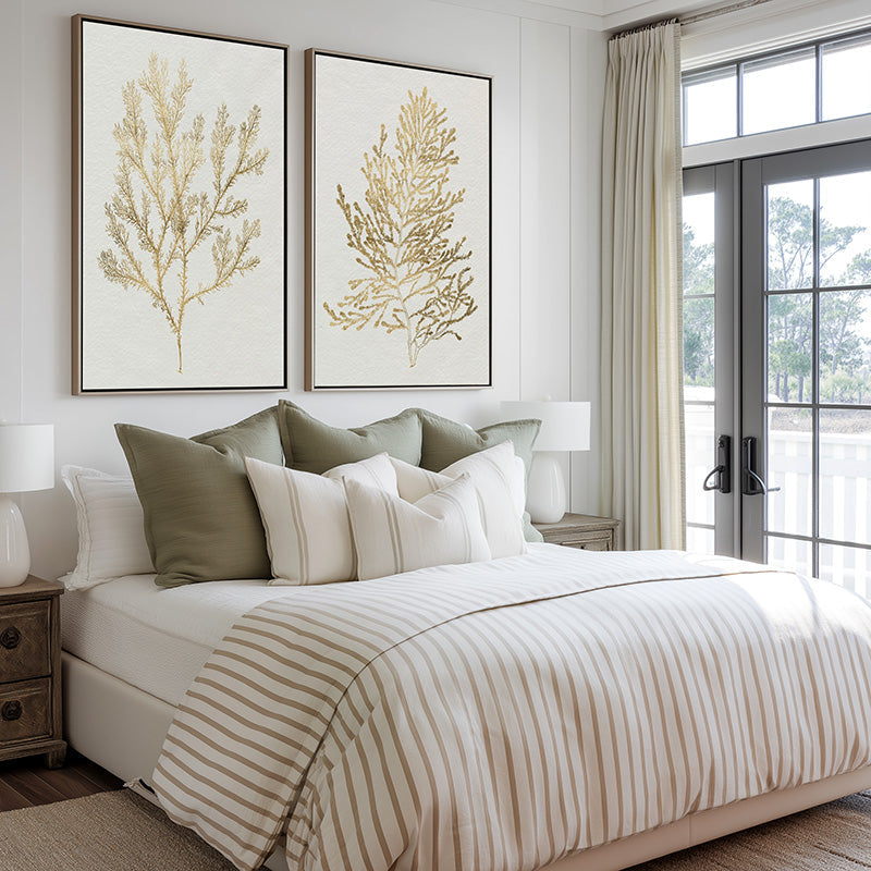 Pair of Gold Coral Coastal Artwork hanging above a plush king size bed covered with cotton linen.