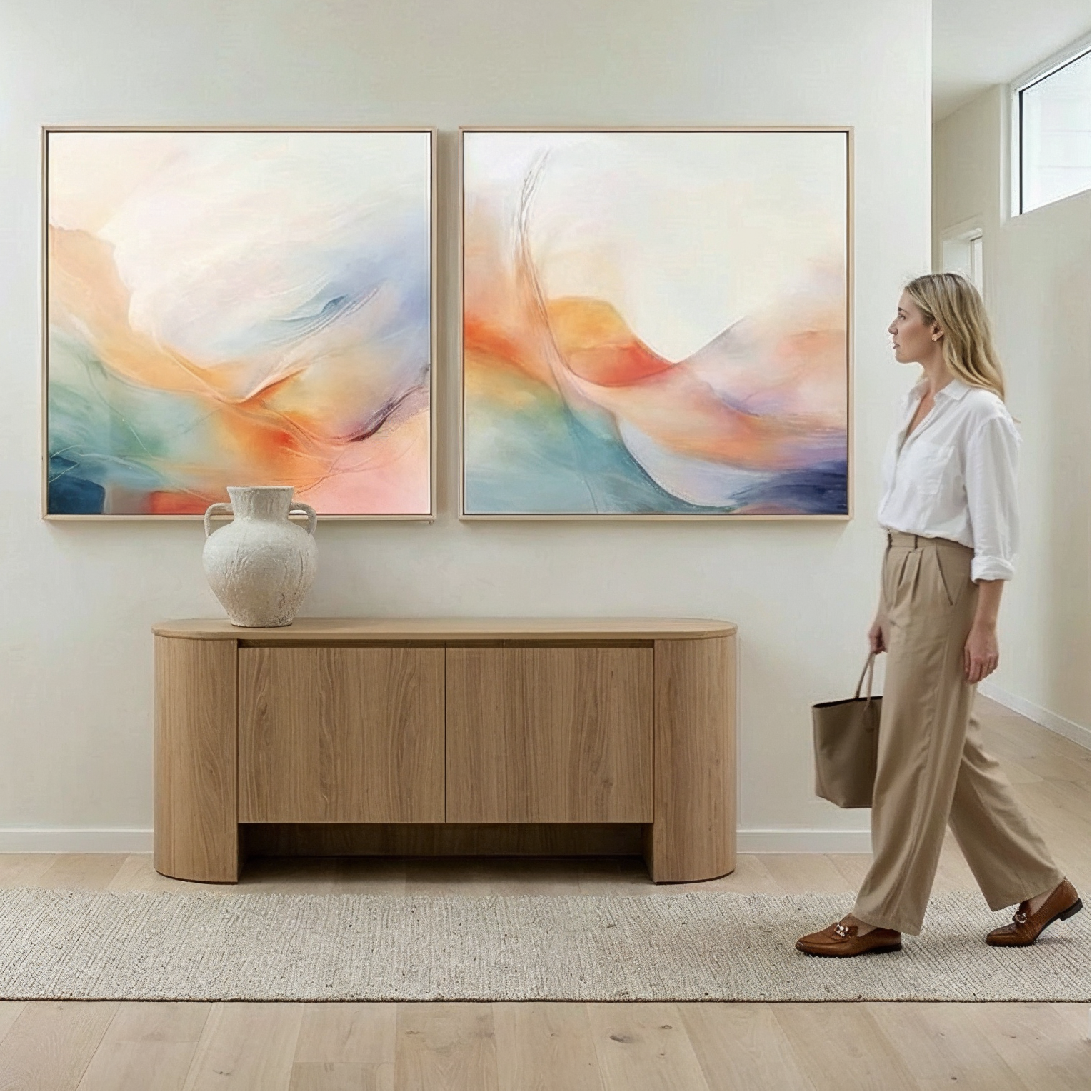 Woman walking in a modern home interior with abstract art on the wall.